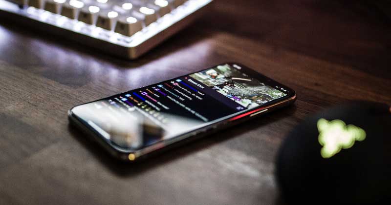 A Handheld Device On Top Of A Wooden Table Indicating User Privacy At A Time Of Pandemic